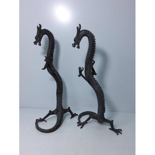 99 - Pair of cast bronze dragons, 40cms in height