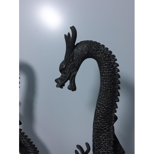 99 - Pair of cast bronze dragons, 40cms in height