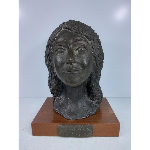 152 - Large mounted female bust on wooden base by David Kelly 1972, approx 35cms in height