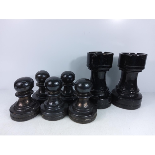 154 - 7 garden terracotta chess set pieces in black glaze, small pieces approx 17cms, larger pieces approx... 