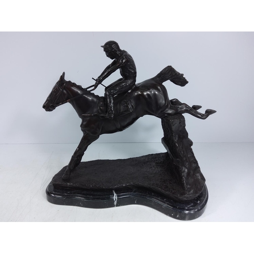 228 - Cast bronze figure of a jump jockey on marble base, 32 x 35cms