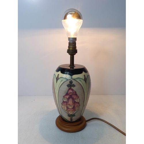 155 - Floral decorated Moorcroft lamp, 28cms in height