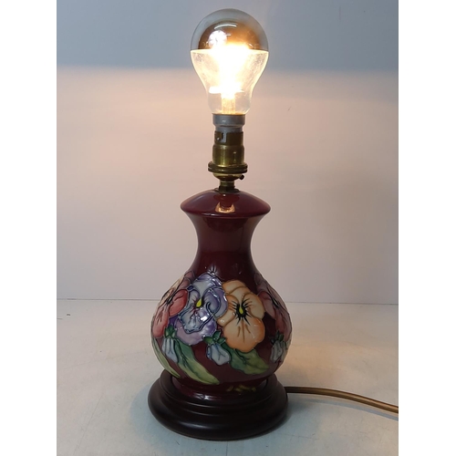 156 - Floral decorated Moorcroft lamp, 24cms in height