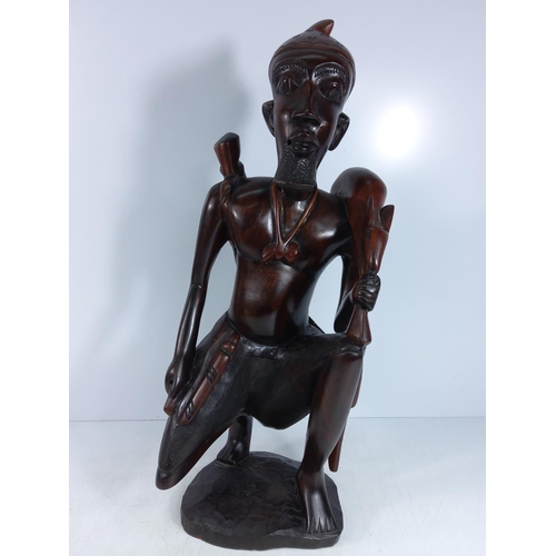 179 - Large carved hardwood tribal figure and a tribal mask