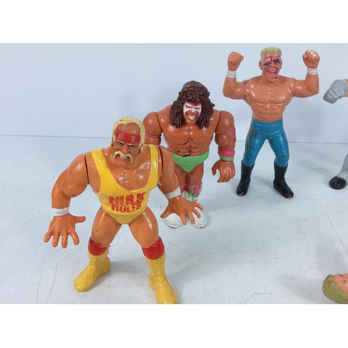 206 - Box of wrestlers and action figures including Ghostbuster characters, He-Man & Battle Cat, The Simps... 