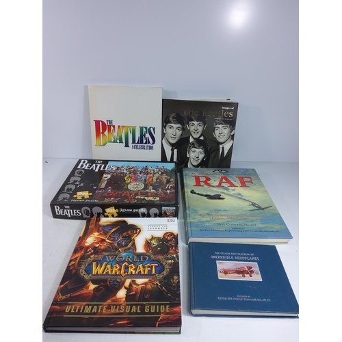 212 - Various books including World of Warcraft and the Beatles and a Beatles puzzle