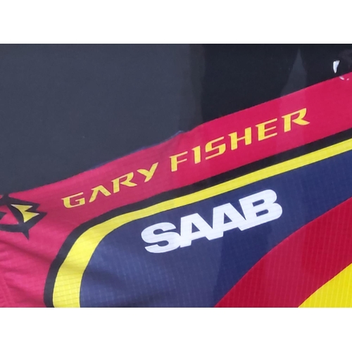 110 - Mounted Gary Fisher racing jersey signed, 102 x 84cms