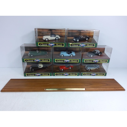 57 - Corgi wooden display plinth with boxed model vehicles