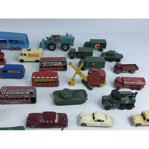 66 - Tin of various vintage model vehicles including military