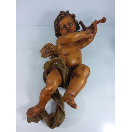 110 - Pair of cherubs playing instruments, approx 56cms in height