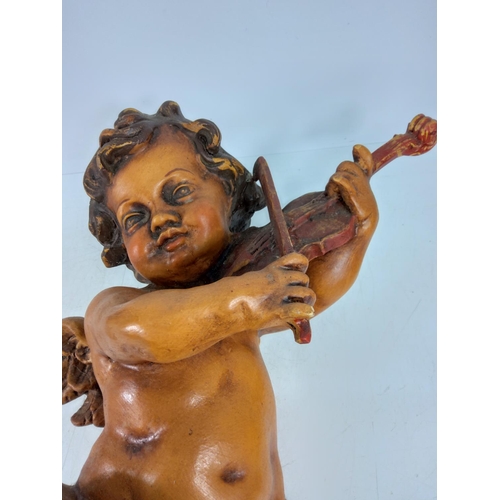 110 - Pair of cherubs playing instruments, approx 56cms in height