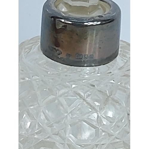 304 - Silver topped cut glass bottle, 15cms in height