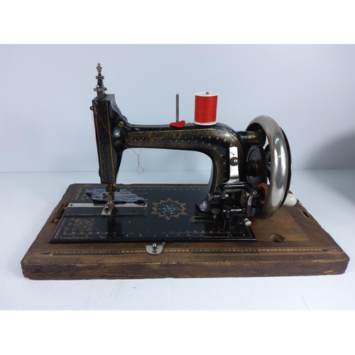 166 - Wooden cased sewing machine