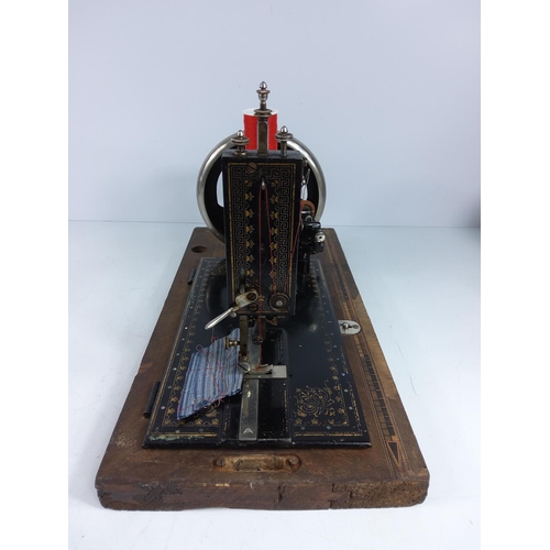 166 - Wooden cased sewing machine