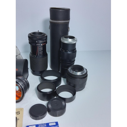 34 - Camera lens, accessories and tripod