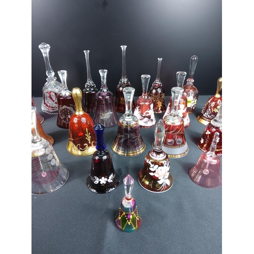 83 - Glass and coloured glass bells including Mary Gregory and ruby and cranberry examples