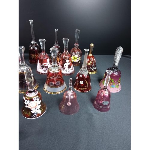 83 - Glass and coloured glass bells including Mary Gregory and ruby and cranberry examples