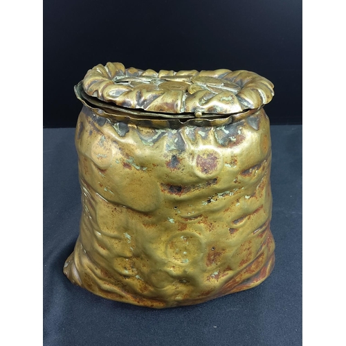 191 - Antique tobacco jar in the form of a bag of coins, 17 x 18cms