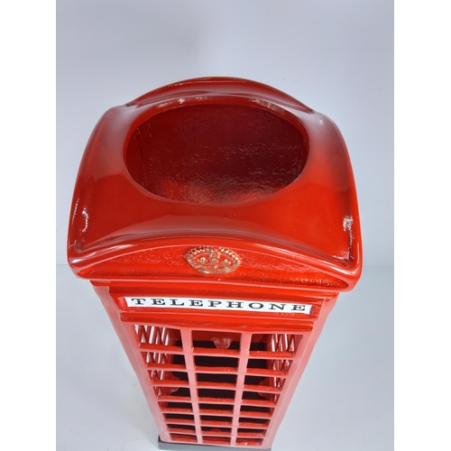 107 - Cast metal telephone box stick stand, 58cms in height