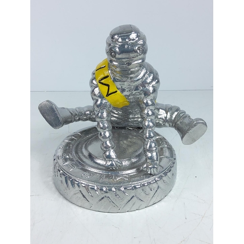 72 - Cast aluminium Michelin man yoga figure, approx 22cms in height