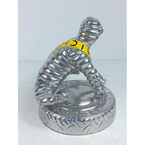 72 - Cast aluminium Michelin man yoga figure, approx 22cms in height