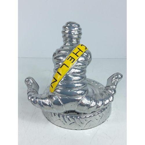 72 - Cast aluminium Michelin man yoga figure, approx 22cms in height