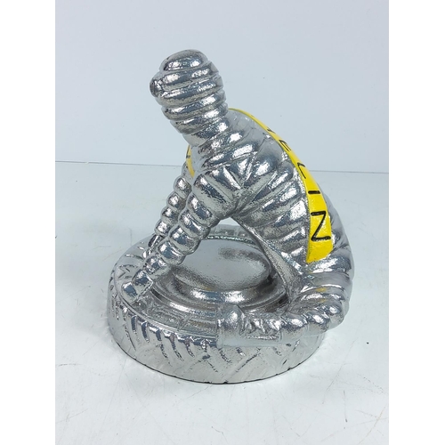 72 - Cast aluminium Michelin man yoga figure, approx 22cms in height