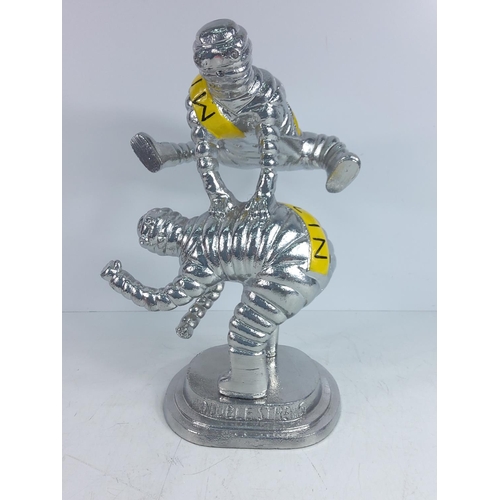 150 - Large cast metal Michelin man leap frog figure