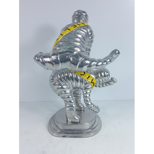 150 - Large cast metal Michelin man leap frog figure