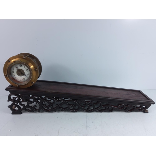 151 - Oriental brass clock on slopped stand