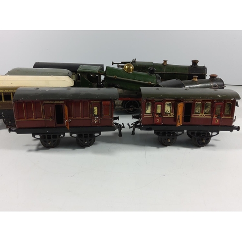 134 - 3 Vintage clockwork engines and 5 carriages / rolling stock