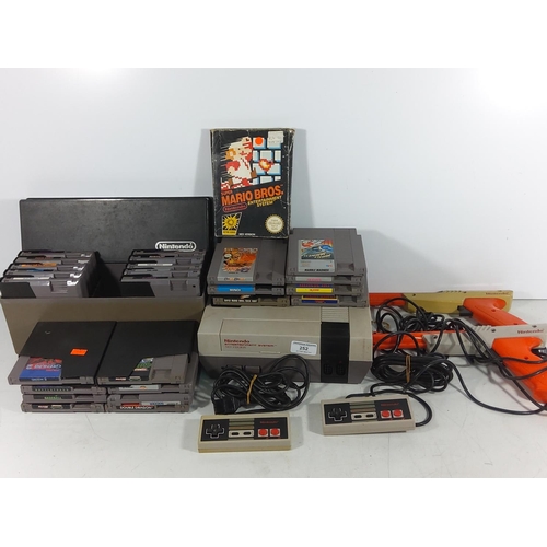 252 - Nintendo entertainment system complete with controllers and large selection of vintage cartridge gam... 