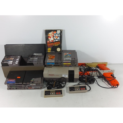 252 - Nintendo entertainment system complete with controllers and large selection of vintage cartridge gam... 