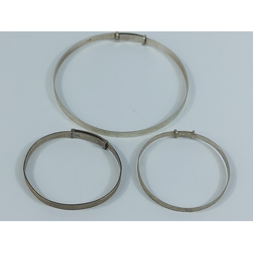 221 - 2 silver baby bangles and an adult bangle, 12.4g