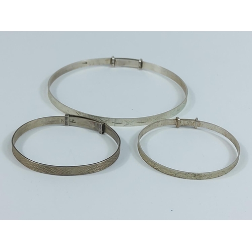 221 - 2 silver baby bangles and an adult bangle, 12.4g