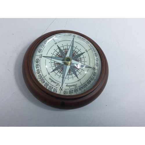 281 - Wooden mounted compass, 9cms in diameter