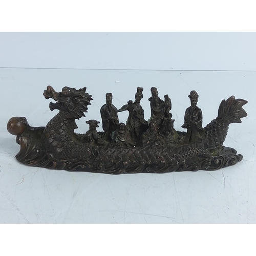 282 - Cast bronze dragon boat with figures, 17cms in length