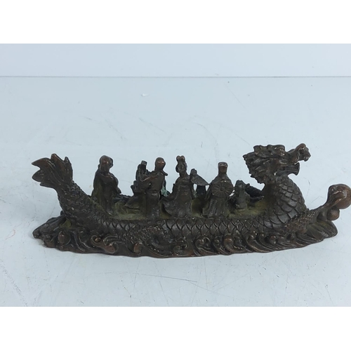 282 - Cast bronze dragon boat with figures, 17cms in length