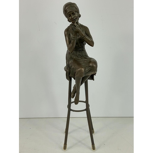 209 - Bronze figure of an art deco lady on stool, 28cms in height