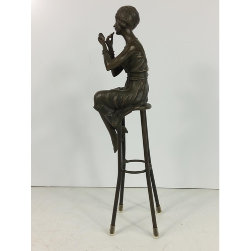 209 - Bronze figure of an art deco lady on stool, 28cms in height