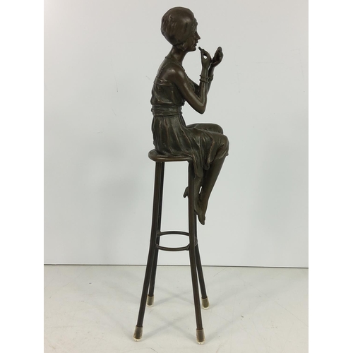 209 - Bronze figure of an art deco lady on stool, 28cms in height