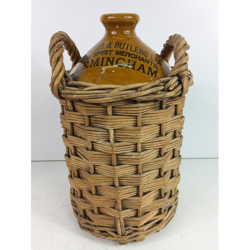 92 - Victorian stoneware beer flagon for Mitchells & Butlers Ltd of Birmingham in a wicker basket