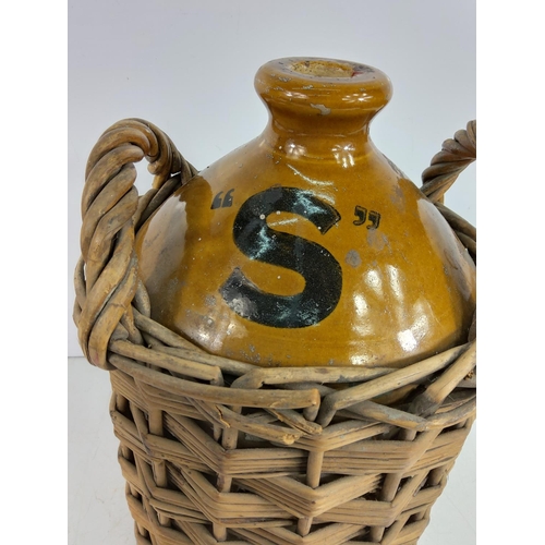 92 - Victorian stoneware beer flagon for Mitchells & Butlers Ltd of Birmingham in a wicker basket