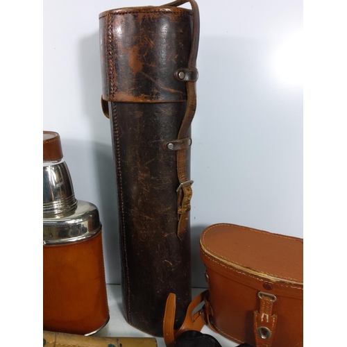 124 - Various leather bound bottles and cases, holster and binoculars, trousers etc including military