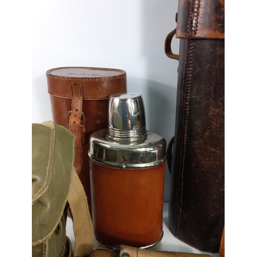 124 - Various leather bound bottles and cases, holster and binoculars, trousers etc including military