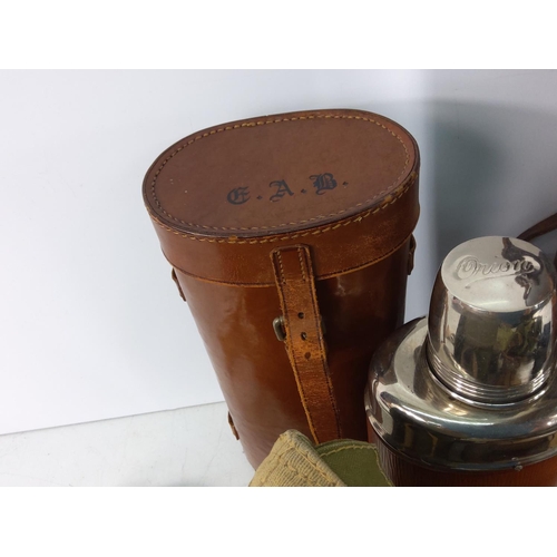 124 - Various leather bound bottles and cases, holster and binoculars, trousers etc including military