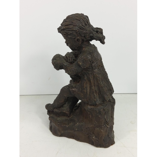 634 - Cold cast figure of a girl and dog, 18cms