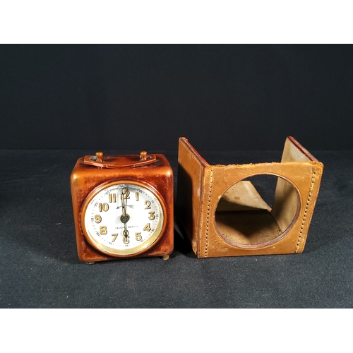 133 - Leather cased german traveling clock and Small Bedroom clock with day and date by Looping