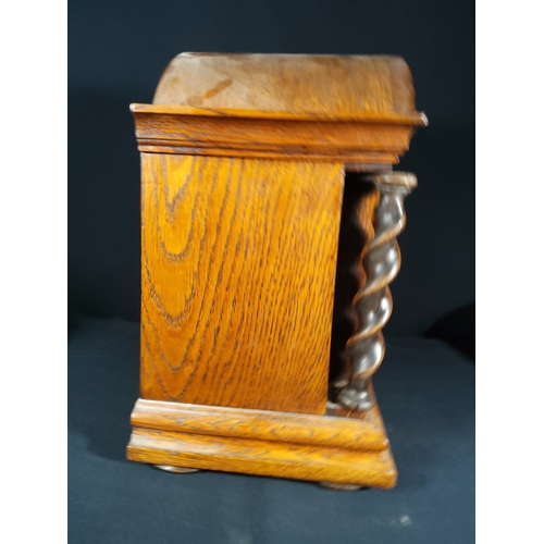 137 - Antique oak cased bracket clock with barley twist columns, 32cms in height