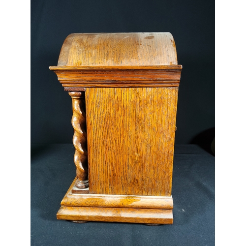 137 - Antique oak cased bracket clock with barley twist columns, 32cms in height